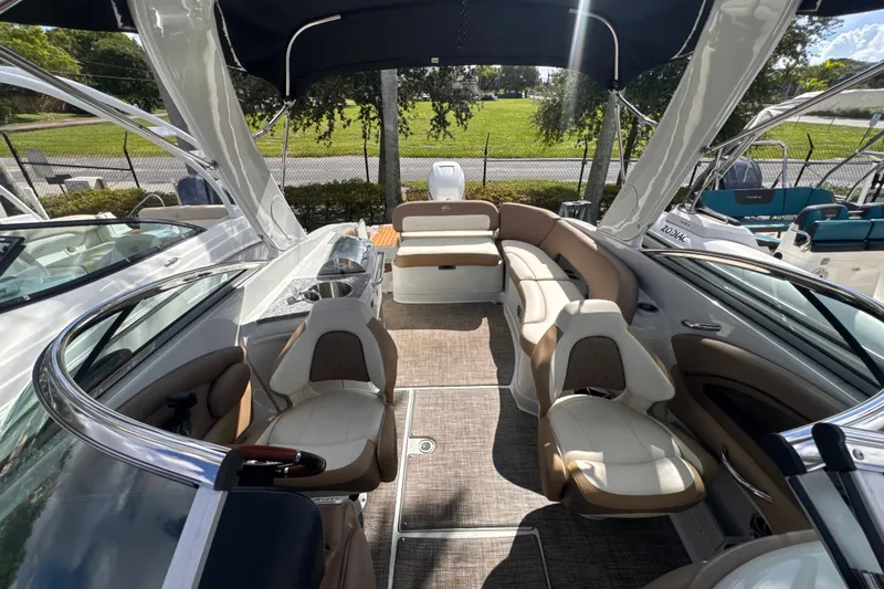 Slide: The Image of 2022 Crownline Eclipse E285 XS boat interior with luxurious seating and canopy. - 15