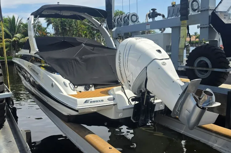 Slide: The Image of 2022 Crownline Eclipse E285 XS boat docked with covered deck and outboard motor. - 19