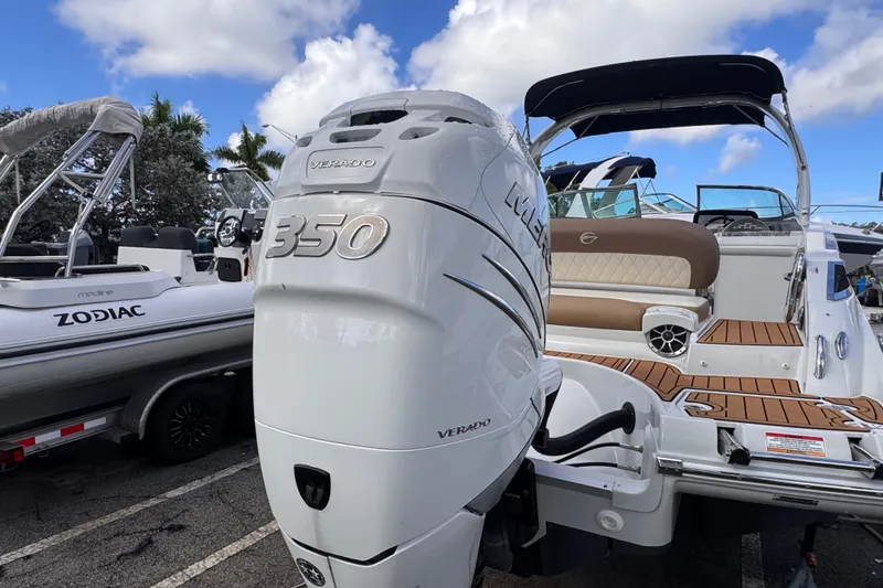 Slide: The Image of 2022 Crownline Eclipse E285 XS boat with Mercury Verado 350 engine, docked beside a Zodiac. - 4