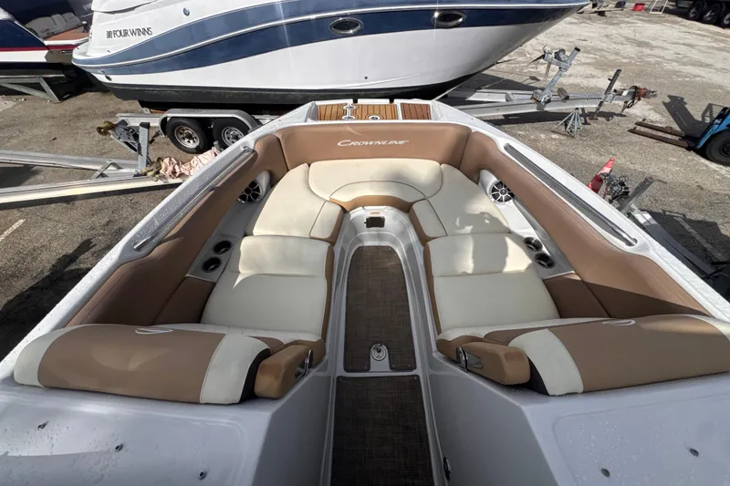Slide: The Image of 2022 Crownline Eclipse E285 XS boat interior with beige and white seating. - 16