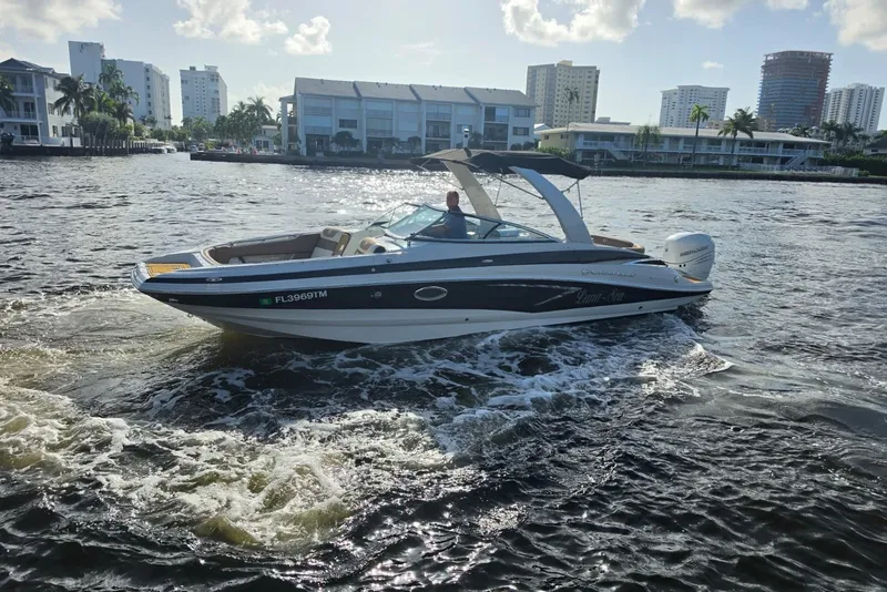 Slide: The Image of 2022 Crownline Eclipse E285 XS boat cruising on a sunny waterfront. - 20