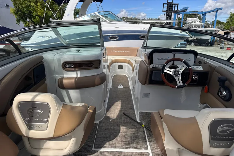 Slide: The Image of 2022 Crownline Eclipse E285 XS boat interior with steering wheel and seating. - 11