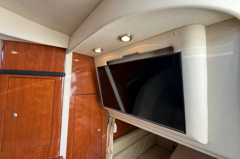 Slide: The Image of Interior of 2007 Sea Ray 340 Sundancer with wood paneling and mounted TV. - 41