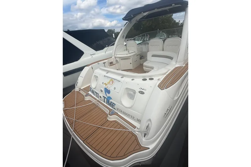 Slide: The Image of 2007 Sea Ray 340 Sundancer yacht with teak deck and white seating, docked at marina. - 16