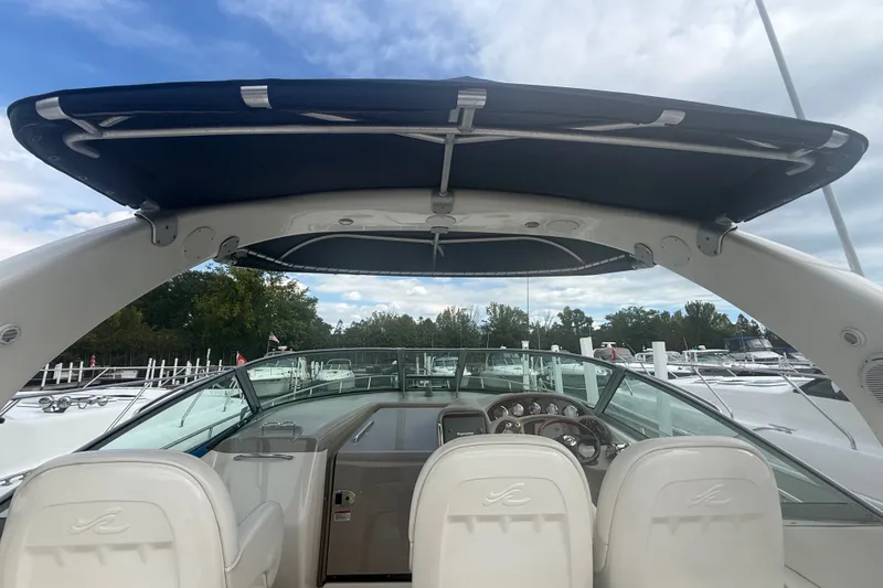 Slide: The Image of 2007 Sea Ray 340 Sundancer boat cockpit with canopy, docked at marina. - 18