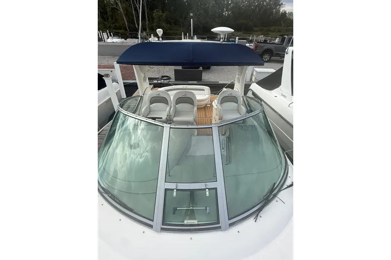 Slide: The Image of 2007 Sea Ray 340 Sundancer boat with blue canopy and sleek windshield design. - 15