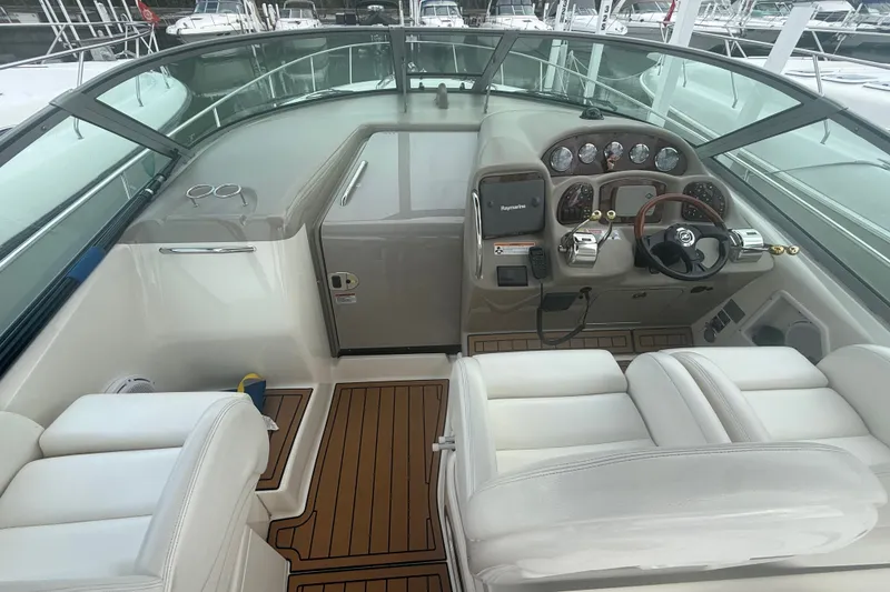 Slide: The Image of 2007 Sea Ray 340 Sundancer helm with white seating and wood accents. - 26