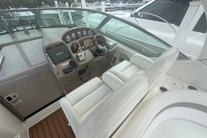 Slide: The Image of 2007 Sea Ray 340 Sundancer helm with modern controls and plush seating. - 27