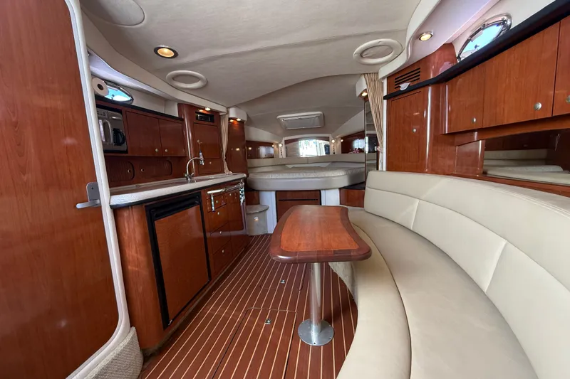Slide: The Image of 2007 Sea Ray 340 Sundancer interior with wood cabinetry, kitchenette, and seating area. - 39