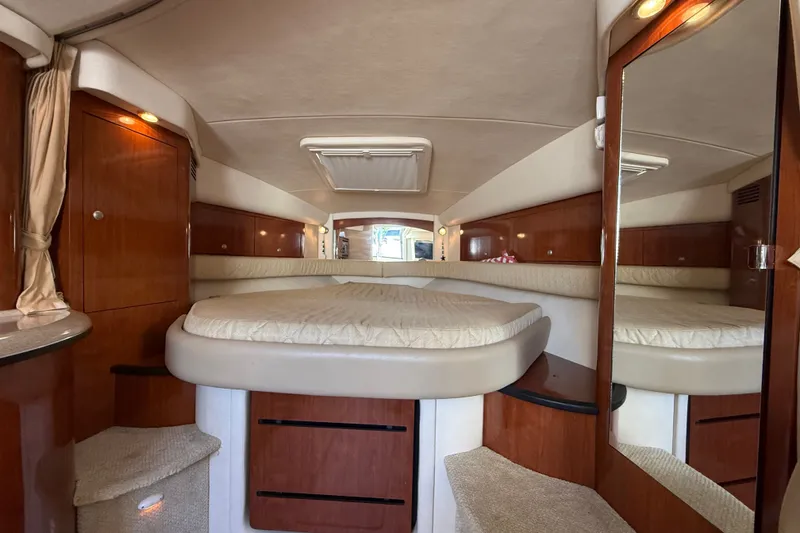 Slide: The Image of Luxurious interior of 2007 Sea Ray 340 Sundancer yacht with cozy bed and wooden cabinetry. - 34