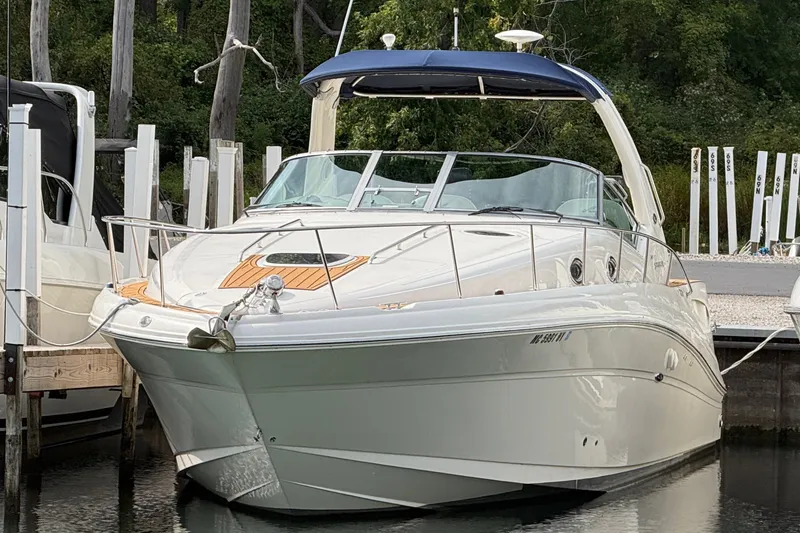 The Image of A 2007 Sea Ray 340 Sundancer docked in a calm area, surrounded by trees. - 0