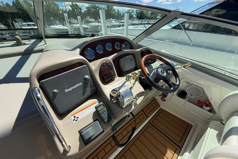 Slide: The Image of Cockpit of 2007 Sea Ray 340 Sundancer with steering wheel and navigation equipment. - 29