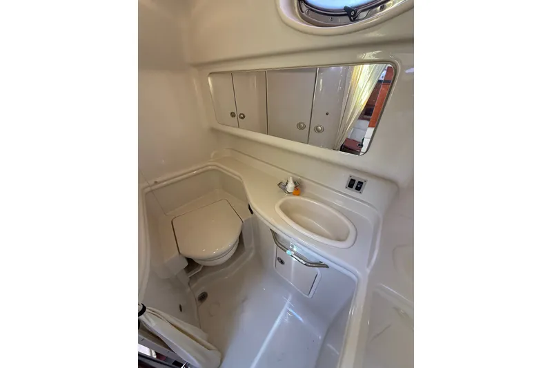 Slide: The Image of 2007 Sea Ray 340 Sundancer bathroom with toilet, sink, and mirrored cabinet. - 42