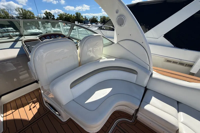 Slide: The Image of 2007 Sea Ray 340 Sundancer cockpit with white seating and wood flooring. - 19