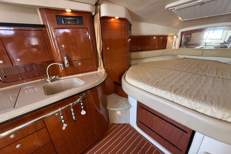Slide: The Image of Luxurious 2007 Sea Ray 340 Sundancer cabin with wood cabinetry and cozy sleeping area. - 33