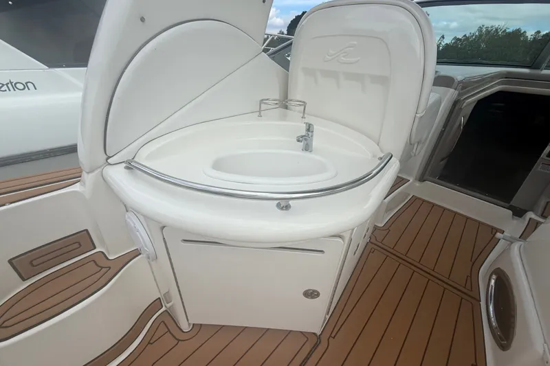 Slide: The Image of 2007 Sea Ray 340 Sundancer boat interior with sink and wooden flooring. - 23