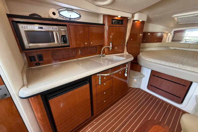 Slide: The Image of Luxurious 2007 Sea Ray 340 Sundancer cabin with kitchenette and cozy sleeping area. - 30