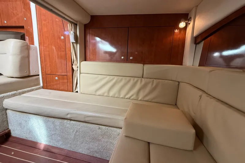 Slide: The Image of Interior of 2007 Sea Ray 340 Sundancer with beige seating and wooden cabinetry. - 38