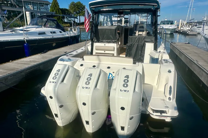 Slide: The Image of 2025 Boston Whaler 365 Conquest with triple Mercury 400 V10 engines docked at marina. - 6