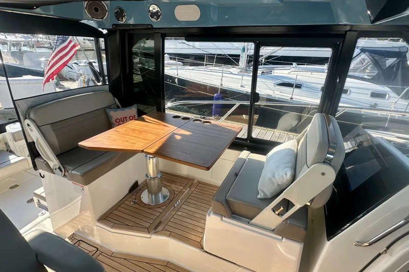 Slide: The Image of Interior of 2025 Boston Whaler 365 Conquest with seating and wooden table. - 9