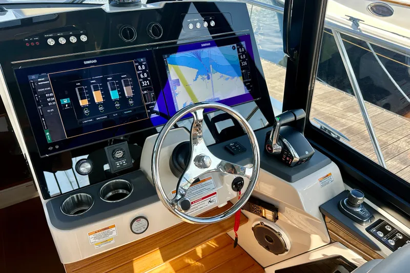 Slide: The Image of Helm of 2025 Boston Whaler 365 Conquest with advanced navigation displays and controls. - 12