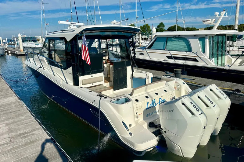Slide: The Image of 2025 Boston Whaler 365 Conquest docked, featuring triple Mercury outboard engines. - 7