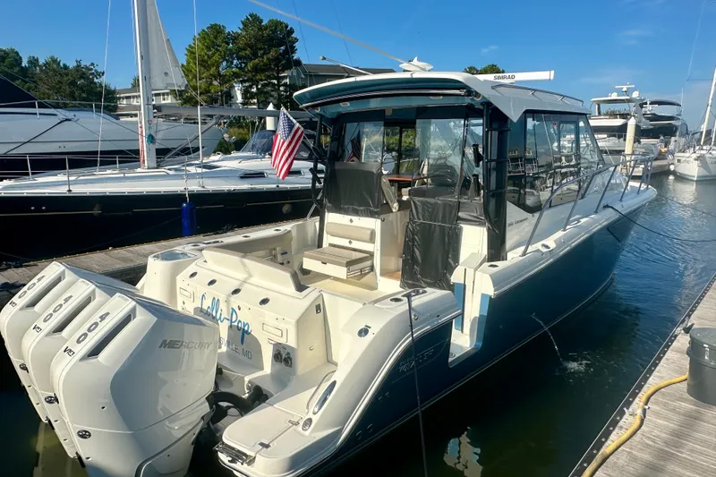 Slide: The Image of 2025 Boston Whaler 365 Conquest docked, featuring triple Mercury engines and sleek design. - 5