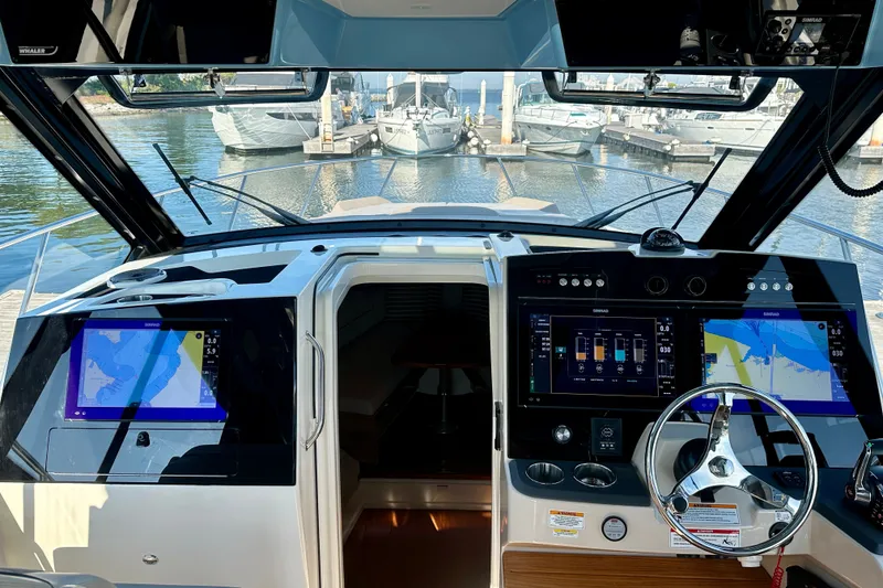 Slide: The Image of Cockpit view of 2025 Boston Whaler 365 Conquest with advanced navigation displays. - 11