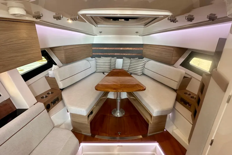 Slide: The Image of Luxurious interior of 2025 Boston Whaler 365 Conquest with elegant seating and wooden table. - 14