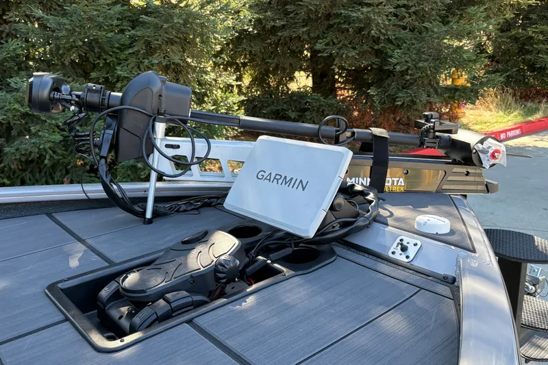 Slide: The Image of 2027 Tracker Savage 215 boat with Garmin and Minn Kota accessories on deck. - 16