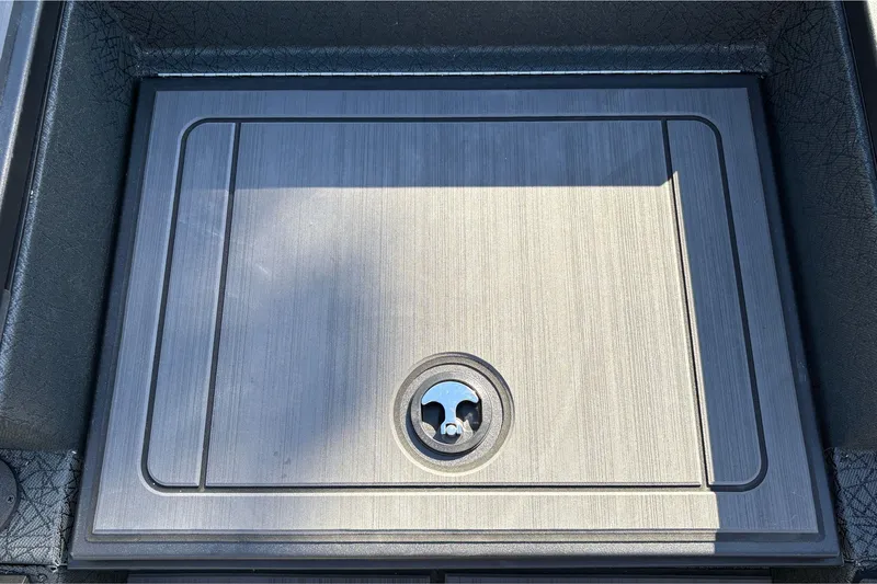 Slide: The Image of 2027 Tracker Savage 215 boat compartment with a sleek, metallic finish and secure lock. - 25