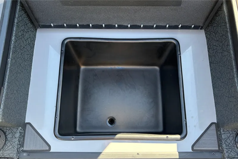 Slide: The Image of Livewell compartment in 2027 Tracker Savage 215 boat, featuring durable black interior. - 26
