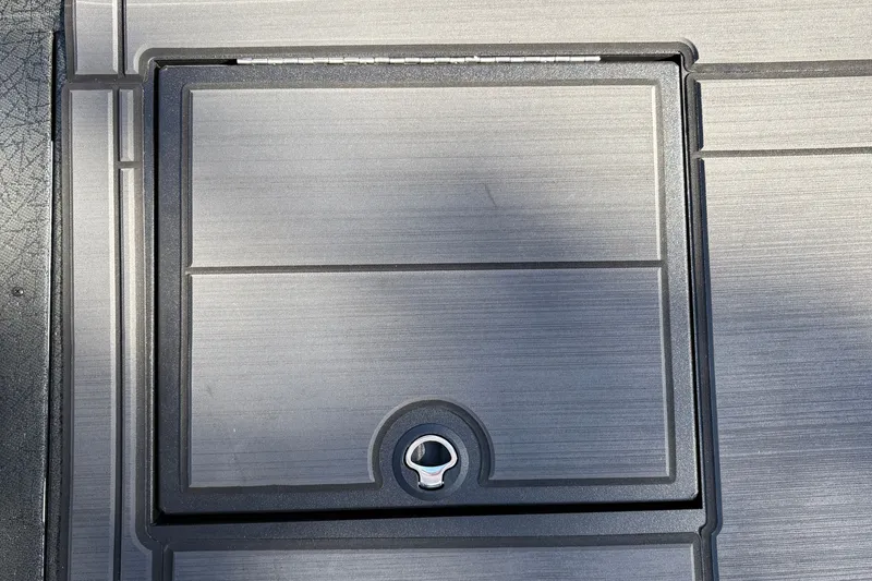 Slide: The Image of Hatch cover on 2027 Tracker Savage 215 boat deck, featuring sleek design and latch. - 31