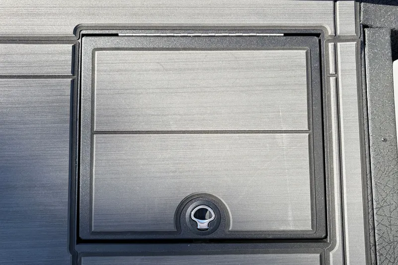 Slide: The Image of 2027 Tracker Savage 215 boat compartment with a secure latch, featuring a sleek, modern design. - 29