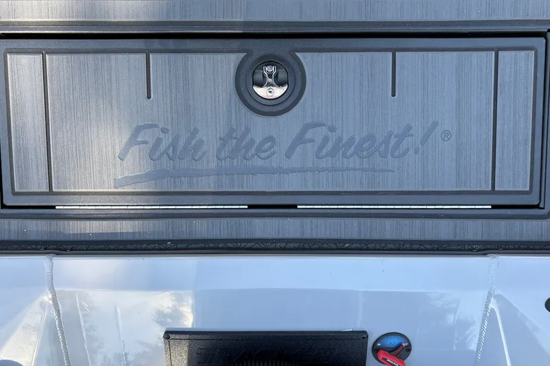 Slide: The Image of 2027 Tracker Savage 215 boat compartment with "Fish the Finest!" branding. - 37