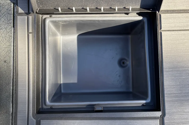 Slide: The Image of Open storage compartment of 2027 Tracker Savage 215 boat, featuring a sleek, durable design. - 36