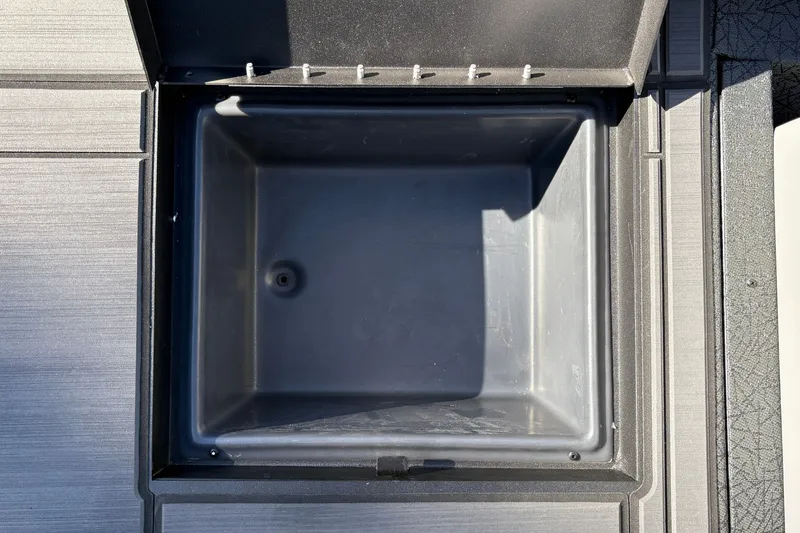 Slide: The Image of Open storage compartment in 2027 Tracker Savage 215 boat. - 35