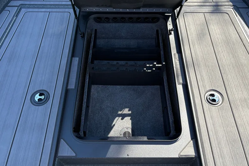 Slide: The Image of Open storage compartment on 2027 Tracker Savage 215 boat, featuring organized interior layout. - 23