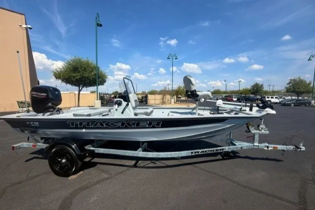The Image of 2027 Tracker Bass Tracker 175 CC boat on trailer, parked outdoors under blue sky. - 0