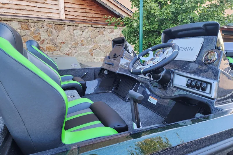 Slide: The Image of Interior of 2027 Nitro Z18 XL Pro boat with green-accented seats and modern dashboard. - 4