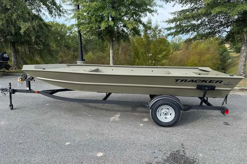 The Image of 2027 Tracker Grizzly 1754 Utility boat on trailer, parked outdoors. - 0