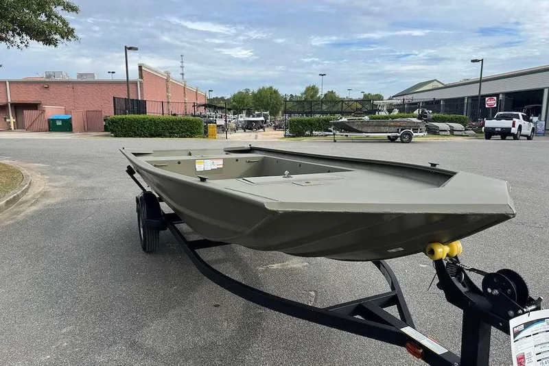 The Image of 2027 Tracker Grizzly 1754 Utility boat on trailer in parking lot. - 0
