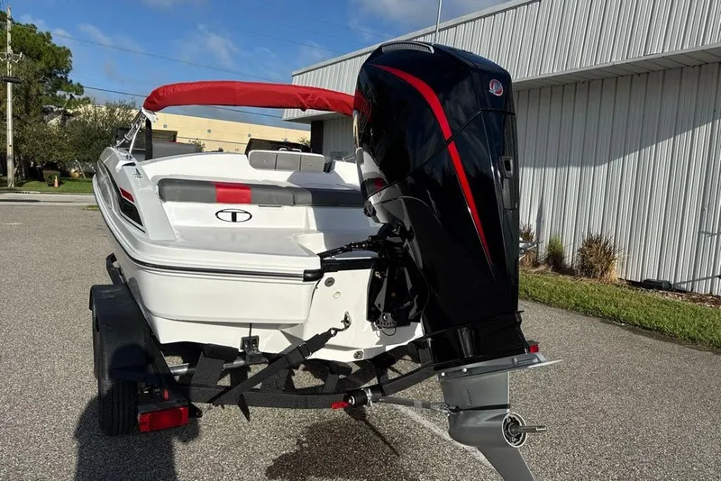 Slide: The Image of 2027 Tahoe T21 boat with red canopy and powerful outboard motor. - 1