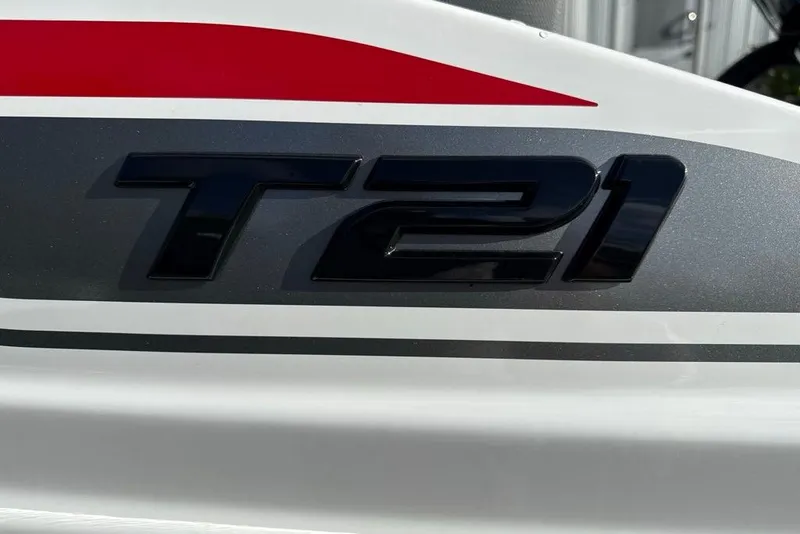 Slide: The Image of 2027 Tahoe T21 logo with sleek black lettering on a white and red background. - 7