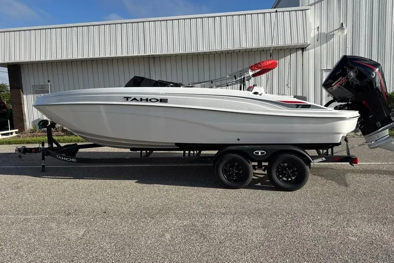 Slide: The Image of 2027 Tahoe T21 boat on trailer, white exterior, parked outdoors. - 3