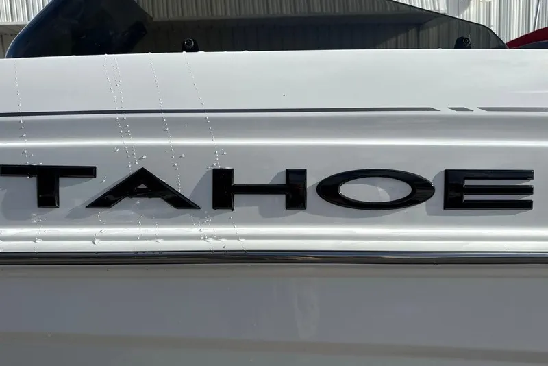 Slide: The Image of Close-up of 2027 Tahoe T21 logo on a sleek white surface. - 4