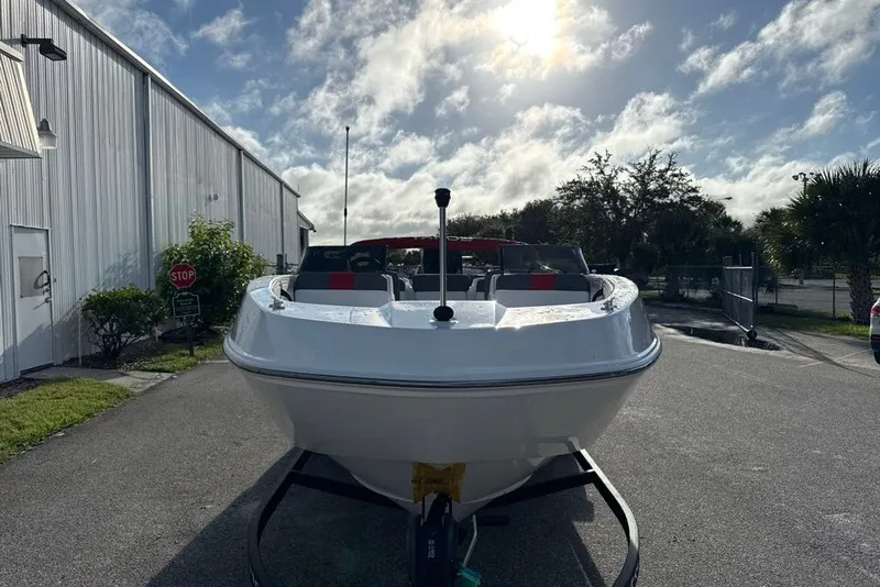 Slide: The Image of Front view of a 2027 Tahoe T21 boat on a trailer under a sunny sky. - 6
