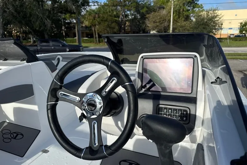 Slide: The Image of Steering wheel and dashboard of 2027 Tahoe T21 boat, featuring modern controls and touchscreen. - 8