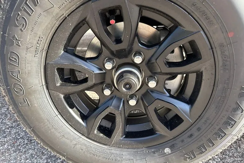 Slide: The Image of Close-up of a 2027 Tahoe T21 black alloy wheel and tire. - 98