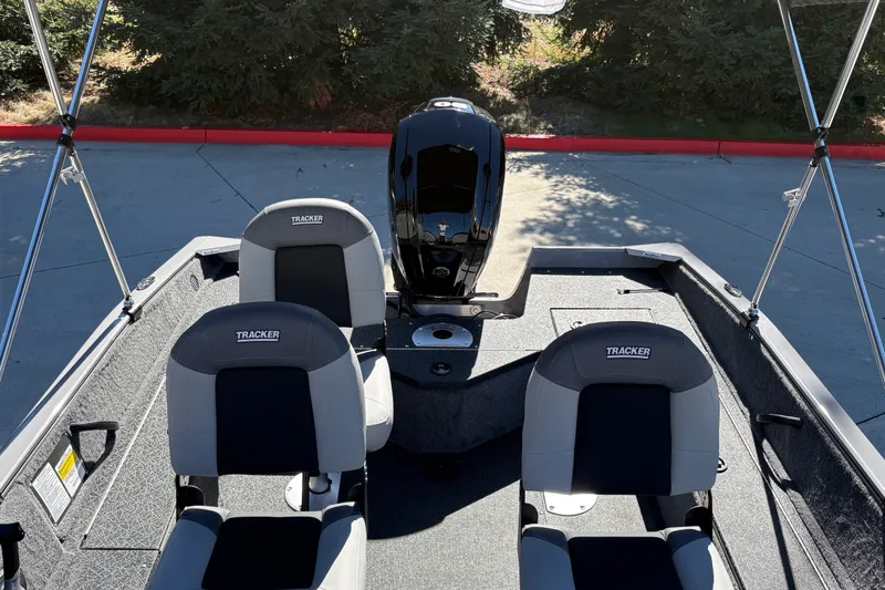 Slide: The Image of 2027 Tracker Pro Guide V-16 SC boat interior with two seats and motor. - 15